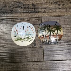 2 painted Sand Dollars with beach scenes signed K.D.